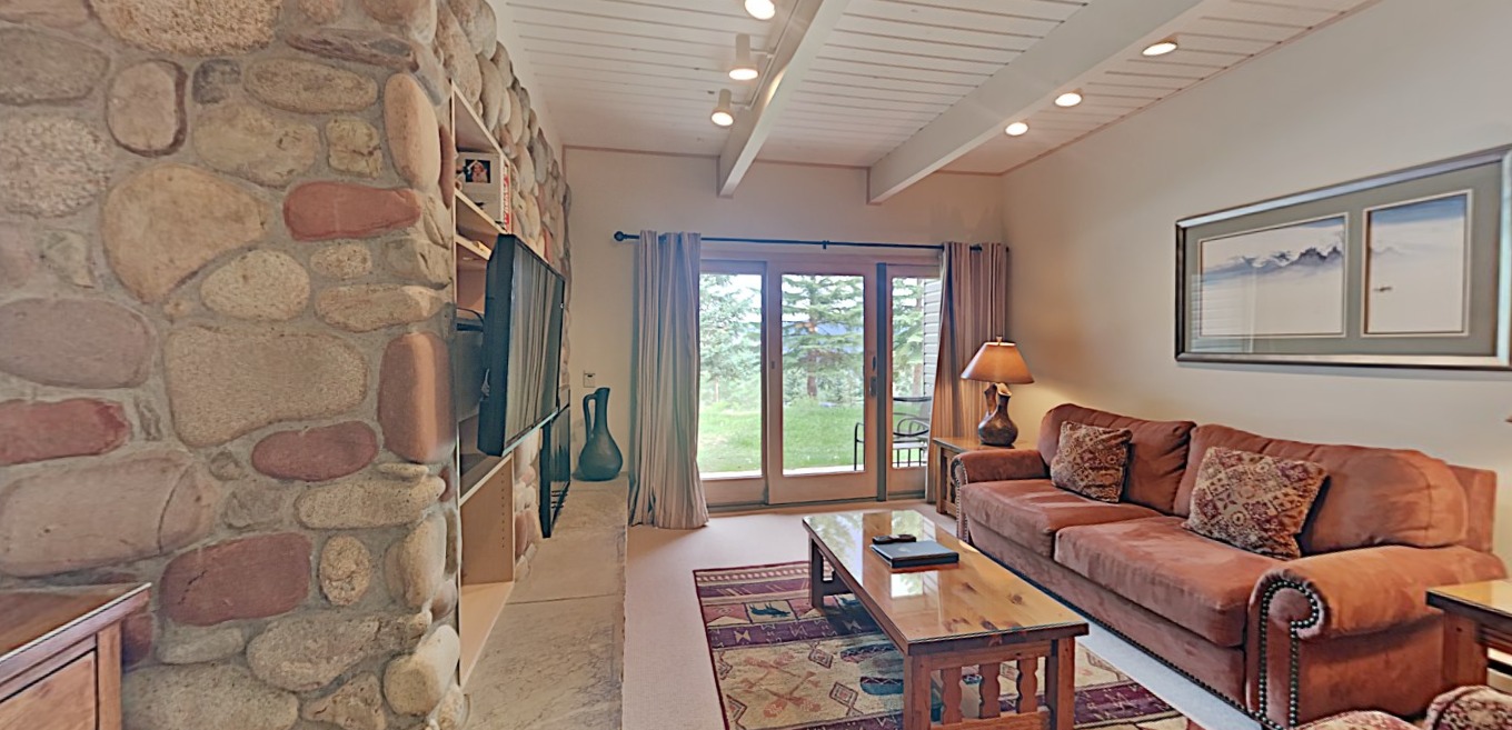 The living room inside of our Snowmass rentals with travel cribs